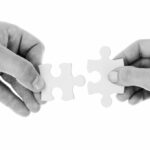 hands holding puzzle pieces