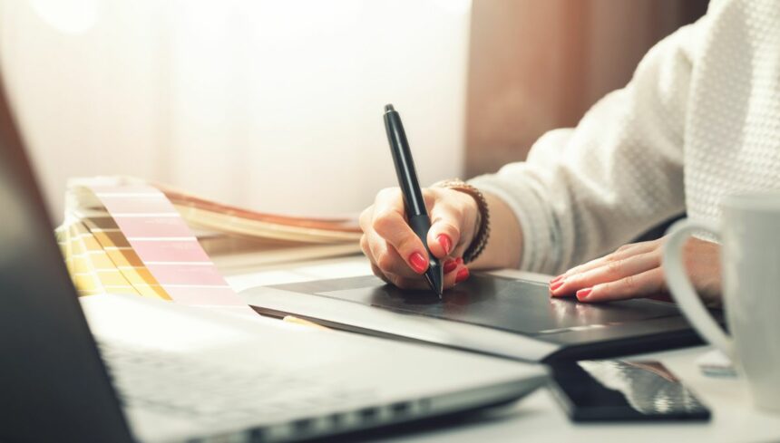 woman graphic designer using tablet for drawing