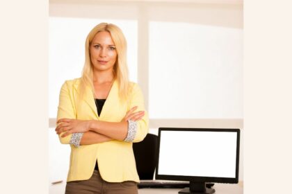 business woman standing near blank screen