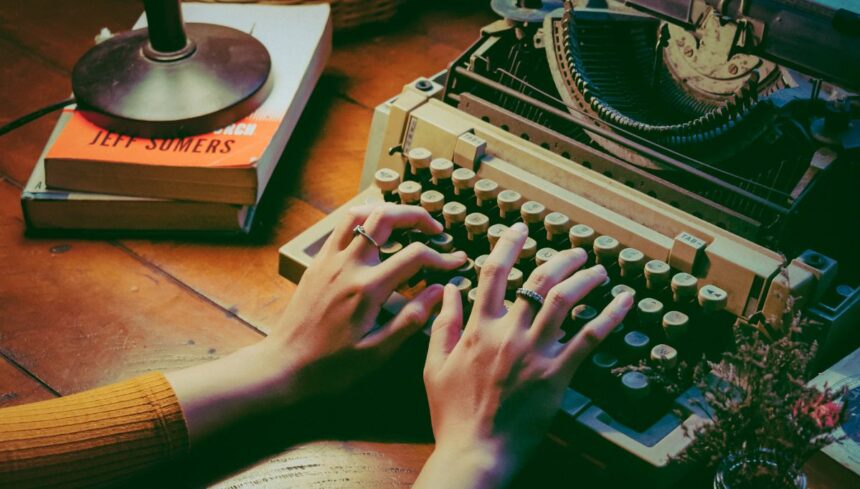 person using typewriter