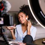 female vlogger recording a makeup tutorial