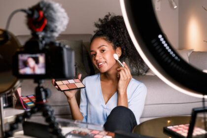 female vlogger recording a makeup tutorial