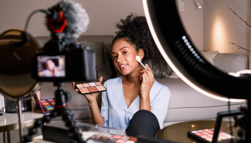 female vlogger recording a makeup tutorial