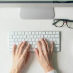 hands typing on keyboard