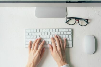 hands typing on keyboard