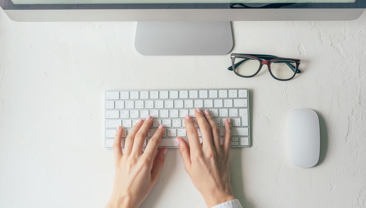 hands typing on keyboard