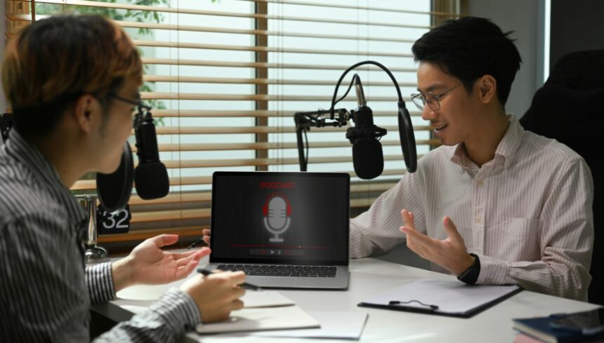 Male radio host using condenser microphone recording voiceover