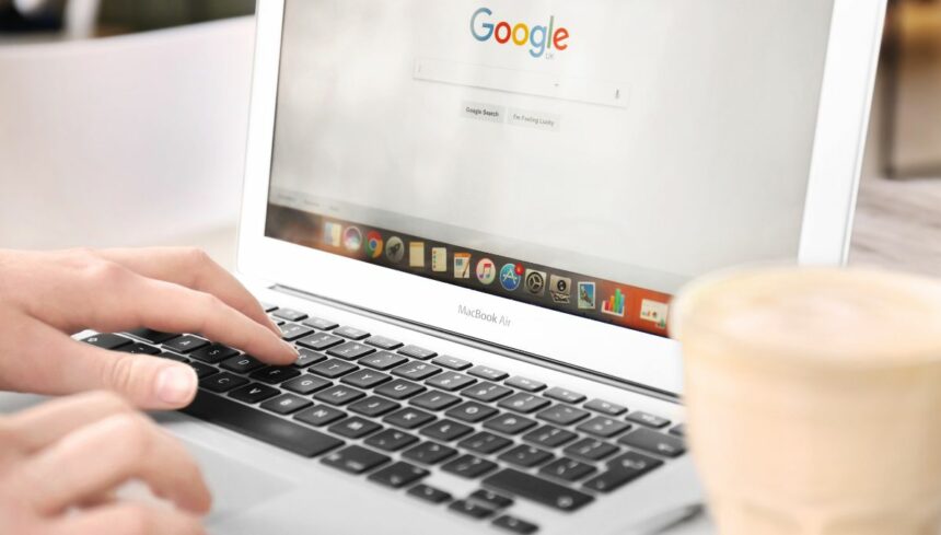 woman using laptop with Google on screen