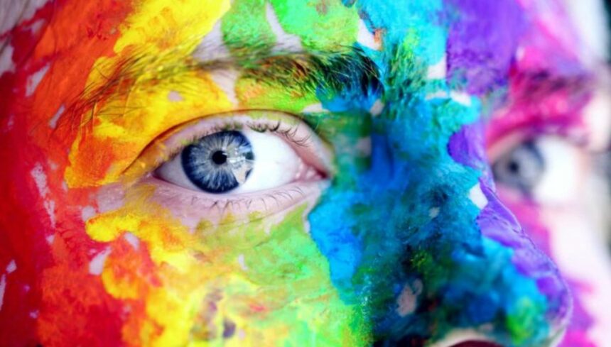 man with face painted with color