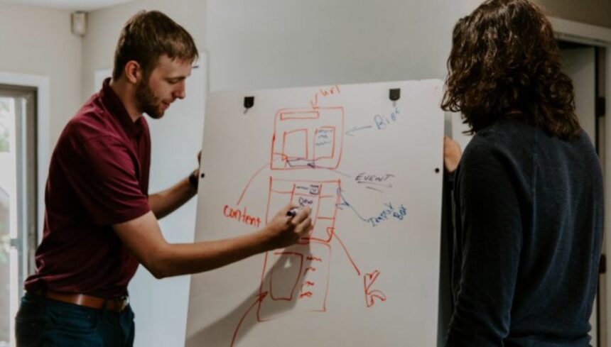 Man teaching on white board