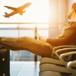 man in airport waiting for boarding on plane