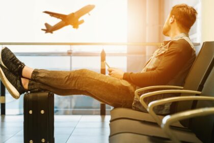 man in airport waiting for boarding on plane