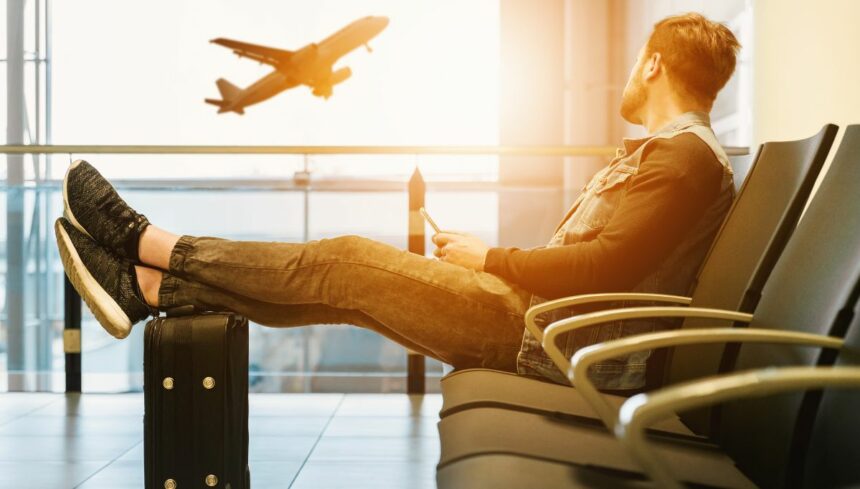 man in airport waiting for boarding on plane