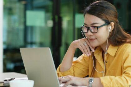 woman wearing headphones engage in online learning