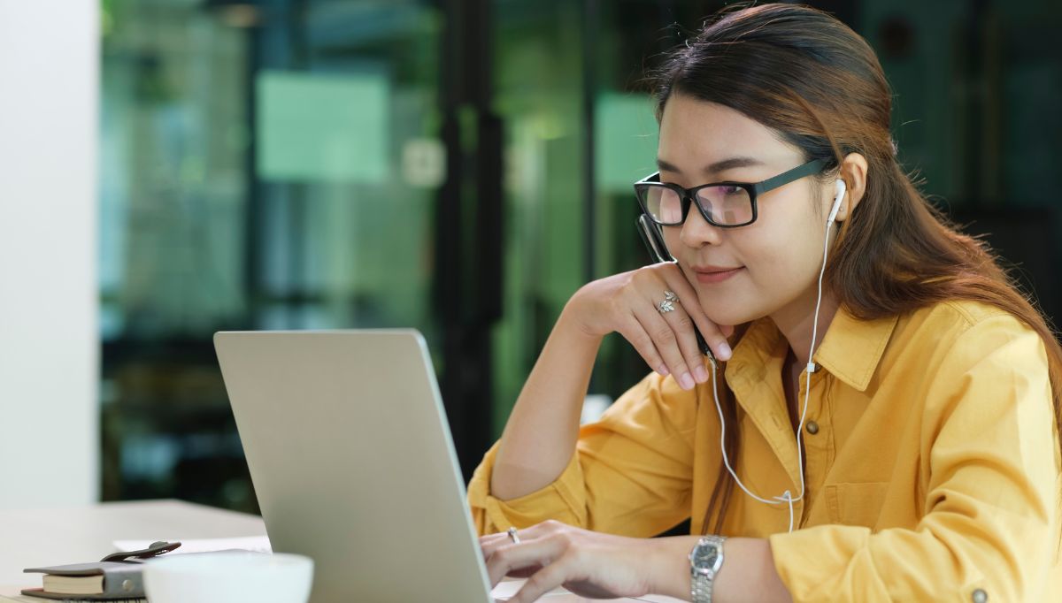 woman wearing headphones engage in online learning