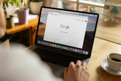 person using mac book pro on table