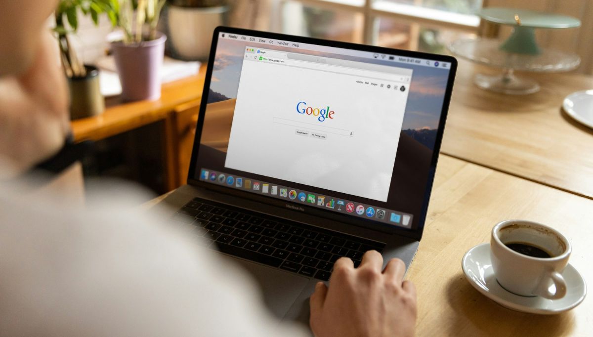 person using mac book pro on table