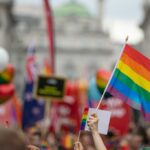 people waving LGBTQ flags