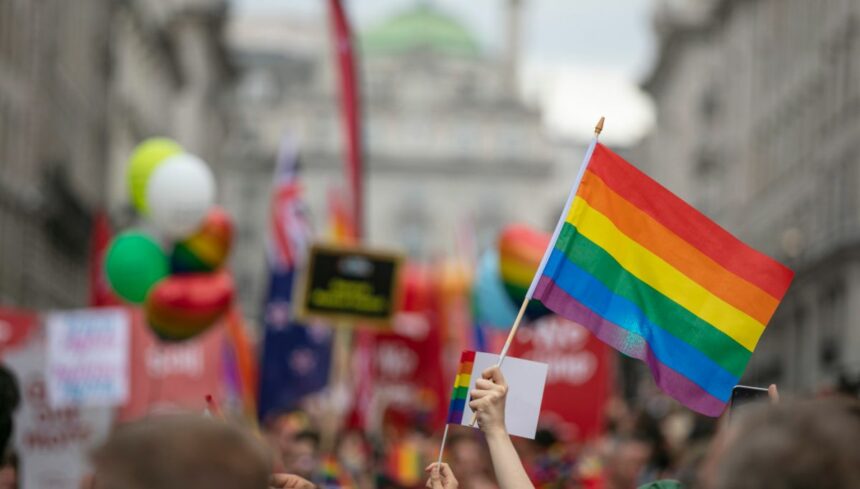 people waving LGBTQ flags